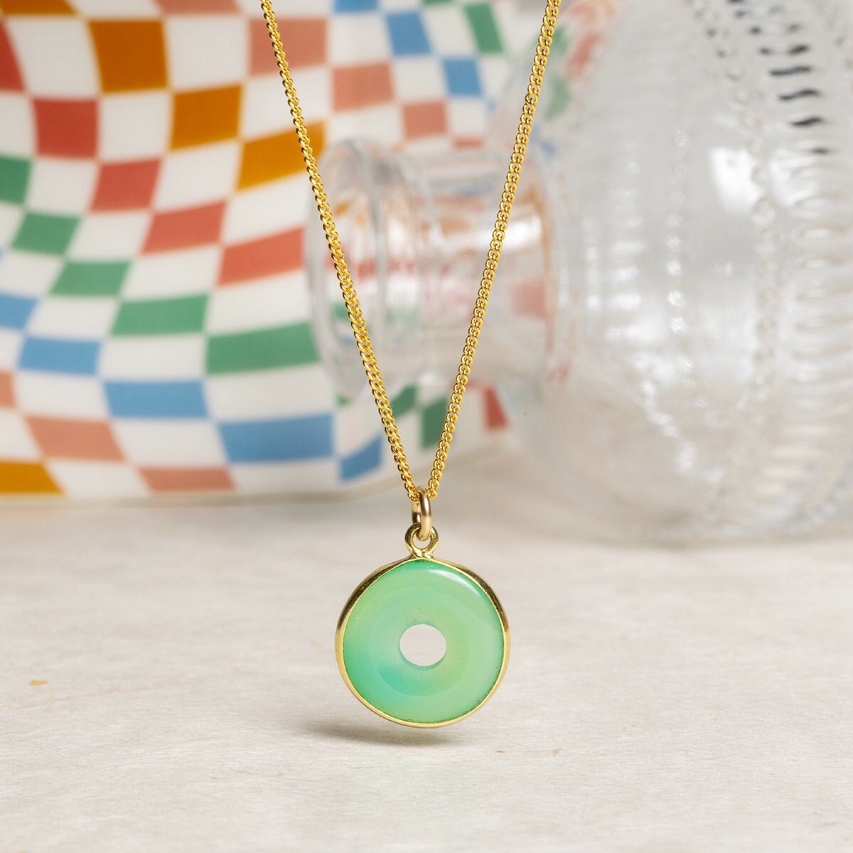 Gold circle ceramic pendant with green dots on a 14k sold gold filled chain